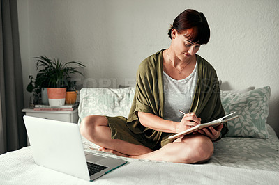 Buy stock photo Full length shot of an attractive young woman writing notes in her diary while relaxing in her bedroom at home