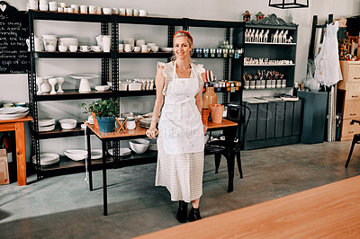 Buy stock photo Cropped portrait of an attractive mature woman standing alone in her pottery workshop during the day