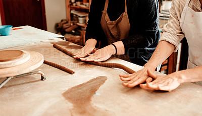 Buy stock photo Pottery, people and hands on clay for roll, teaching and design process in workshop. Sculptor, coaching and rope of mud on table for production, mentoring and ceramic creation for small business