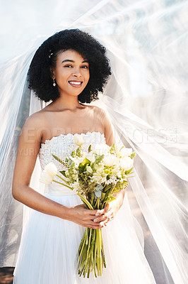 Buy stock photo Portrait of a happy and beautiful young bride holding a bouquet of flowers while posing outdoors on her wedding day