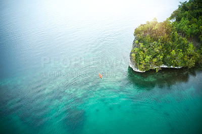 Buy stock photo High angle shot of an adventurous young couple canoeing together in the beautiful oceans of Indonesia