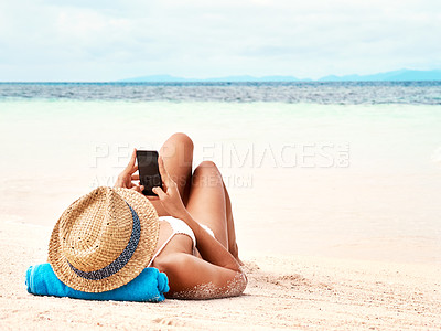 Buy stock photo Travel, phone and woman relaxing on the beach scrolling on social media or mobile app on holiday. Rest, tropical and female person laying on sand by ocean networking on cellphone on summer vacation.