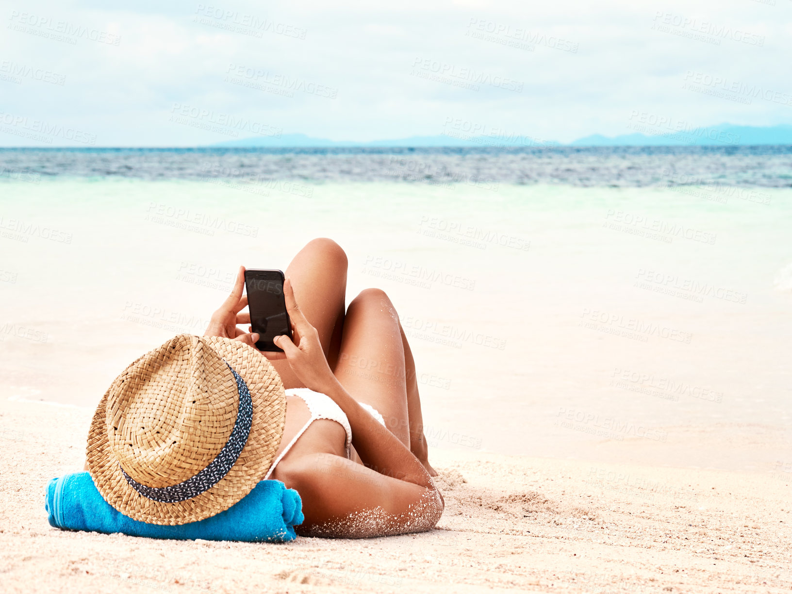 Buy stock photo Travel, phone and woman relaxing on the beach scrolling on social media or mobile app on holiday. Rest, tropical and female person laying on sand by ocean networking on cellphone on summer vacation.