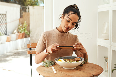 Buy stock photo Cropped shot of an attractive young businesswoman using her cellphone to take pictures of her lunch for her blog