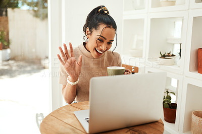 Buy stock photo Cropped shot of an attractive young businesswoman sitting and vlogging on her laptop while enjoying a cup of coffee