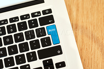 Buy stock photo High angle shot of a highlighted key of a blogger's laptop on a desk during the day