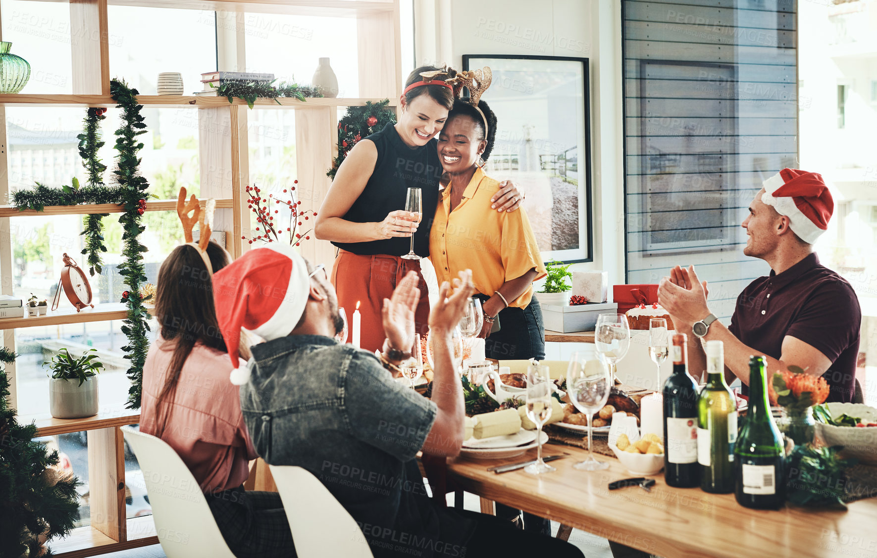 Buy stock photo Christmas, hug and applause with people at dinner party for festive celebration, decoration or winter holiday. Happy, season and xmas eve gathering with friends for support, vacation or tradition