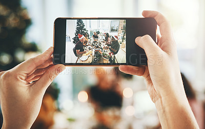 Buy stock photo Cropped shot of an unrecognizable man photographing his friends having Christmas lunch at home