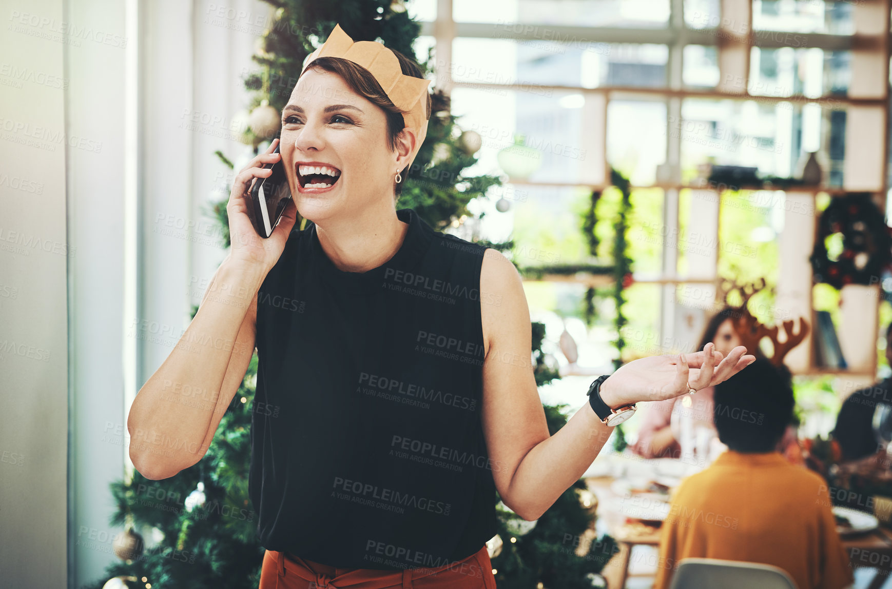 Buy stock photo Christmas, woman and laughing with phone call at dinner for season greeting, holiday celebration and talking in home. Friends, person and contact at fun social gathering for communication and happy