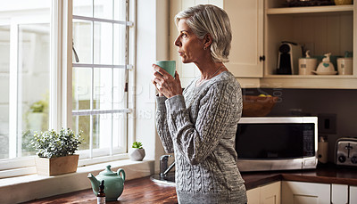 Buy stock photo Cropped shot of a relaxed senior woman preparing a cup of tea with CBD oil inside of it at home during the day