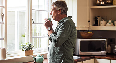 Buy stock photo Cropped shot of a relaxed senior man preparing a cup of tea with CBD oil inside of it at home during the day