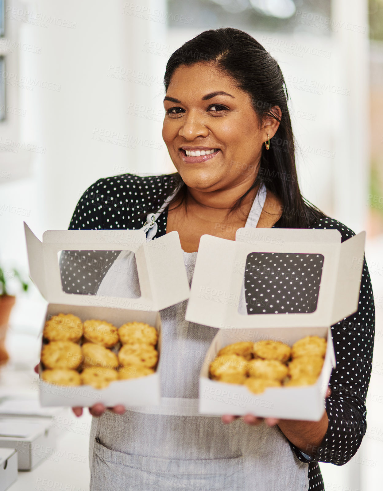 Buy stock photo Shot of a woman showing off her freshly baked goods