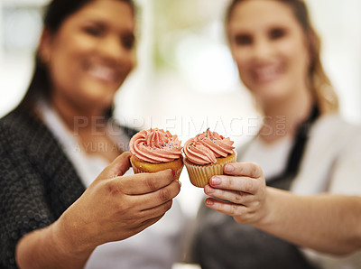 Buy stock photo Cropped shot of two bakers holding cupcakes