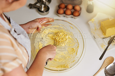 Buy stock photo Cropped shot of an unrecognizable woman mixing batter in a glass bowl