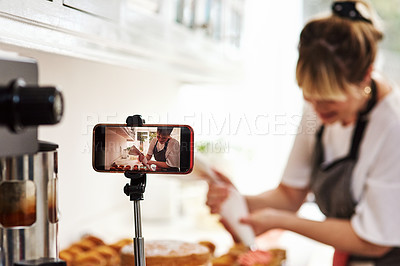 Buy stock photo Cropped shot of a woman being recorded on a cellphone while baking in her kitchen