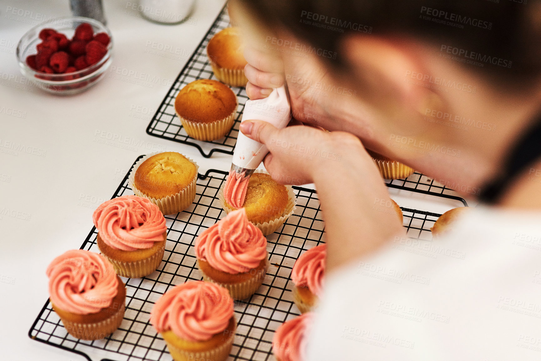 Buy stock photo Woman, baker and cupcake in kitchen icing, start up and business with employee for treat or dessert with packaging. Creative, frosting and order preparation for customer, back view and apron