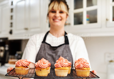 Buy stock photo Woman, smile and tray with cupcakes in kitchen with fresh baked at home with pride for hobby. Small business, portrait and happiness in career with dessert or confidence for cooking in house bakery