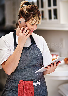 Buy stock photo Shot of a woman talking on her cellphone while looking at a digital tablet