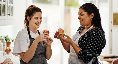 Buy stock photo Cropped shot of two bakers tasting their freshly baked cupcakes