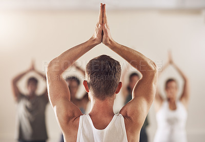 Buy stock photo Rearview shot of a group of young people working out together in a yoga class