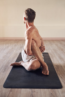 Buy stock photo Full length shot of a flexible young man exercising and stretching in yoga class