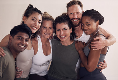 Buy stock photo Portrait of a group of active young people posing together against a wall in yoga class