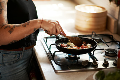 Buy stock photo Cropped shot of a woman preparing a meal at home