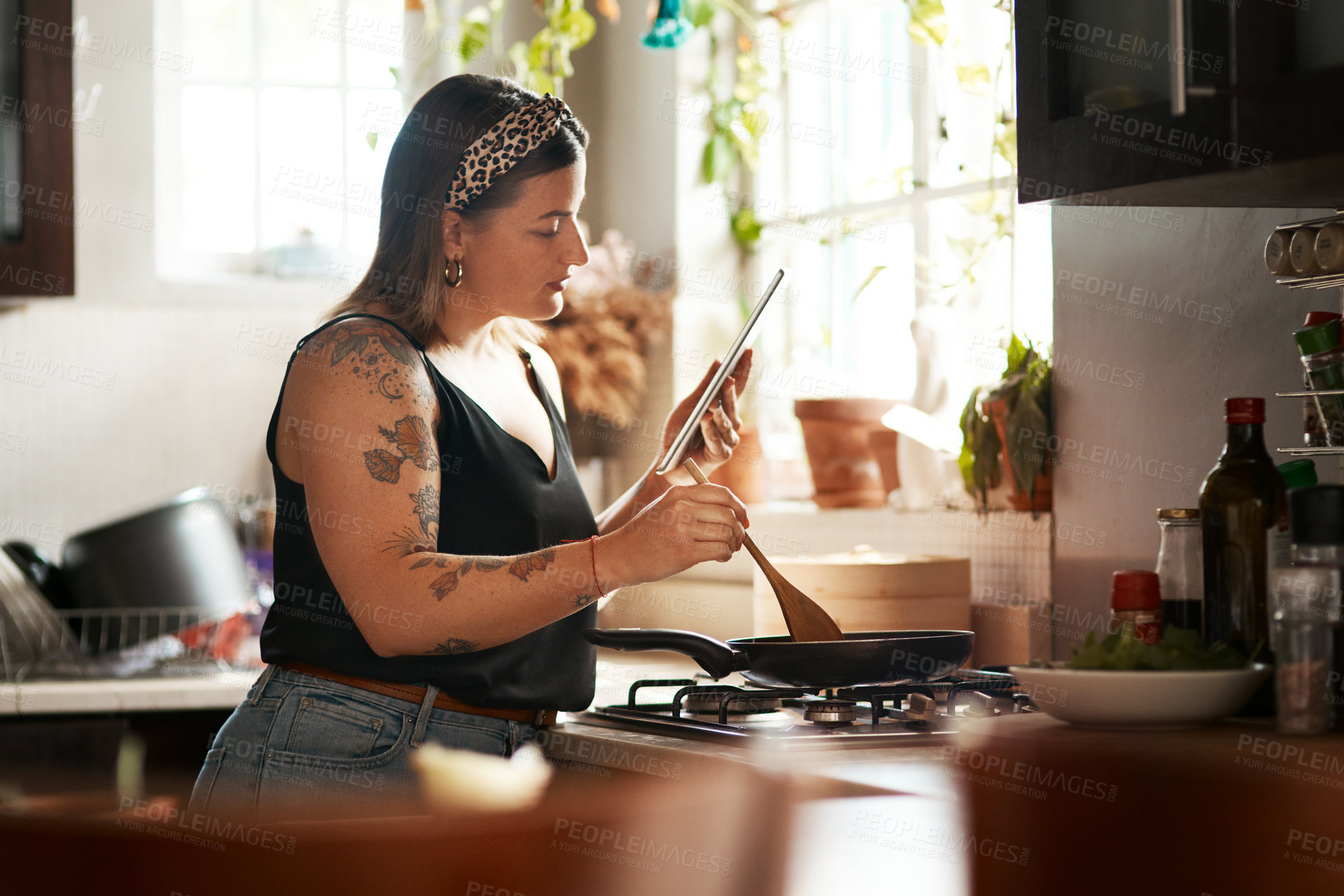 Buy stock photo Woman, reading or tablet in kitchen for cooking, recipe tutorial or streaming lesson online. Girl, meal prep or tech in home for food blog website, nutritional guide app or lunch idea on social media