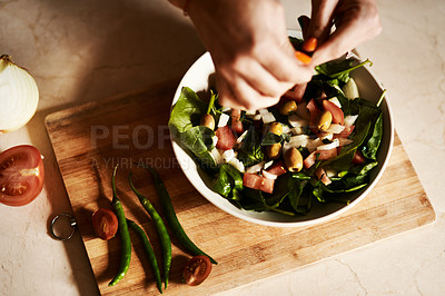 Buy stock photo Cropped shot of a woman preparing a healthy salad at home