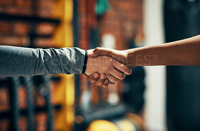 Buy stock photo Cropped shot of two unrecognizable people shaking hands in a gym
