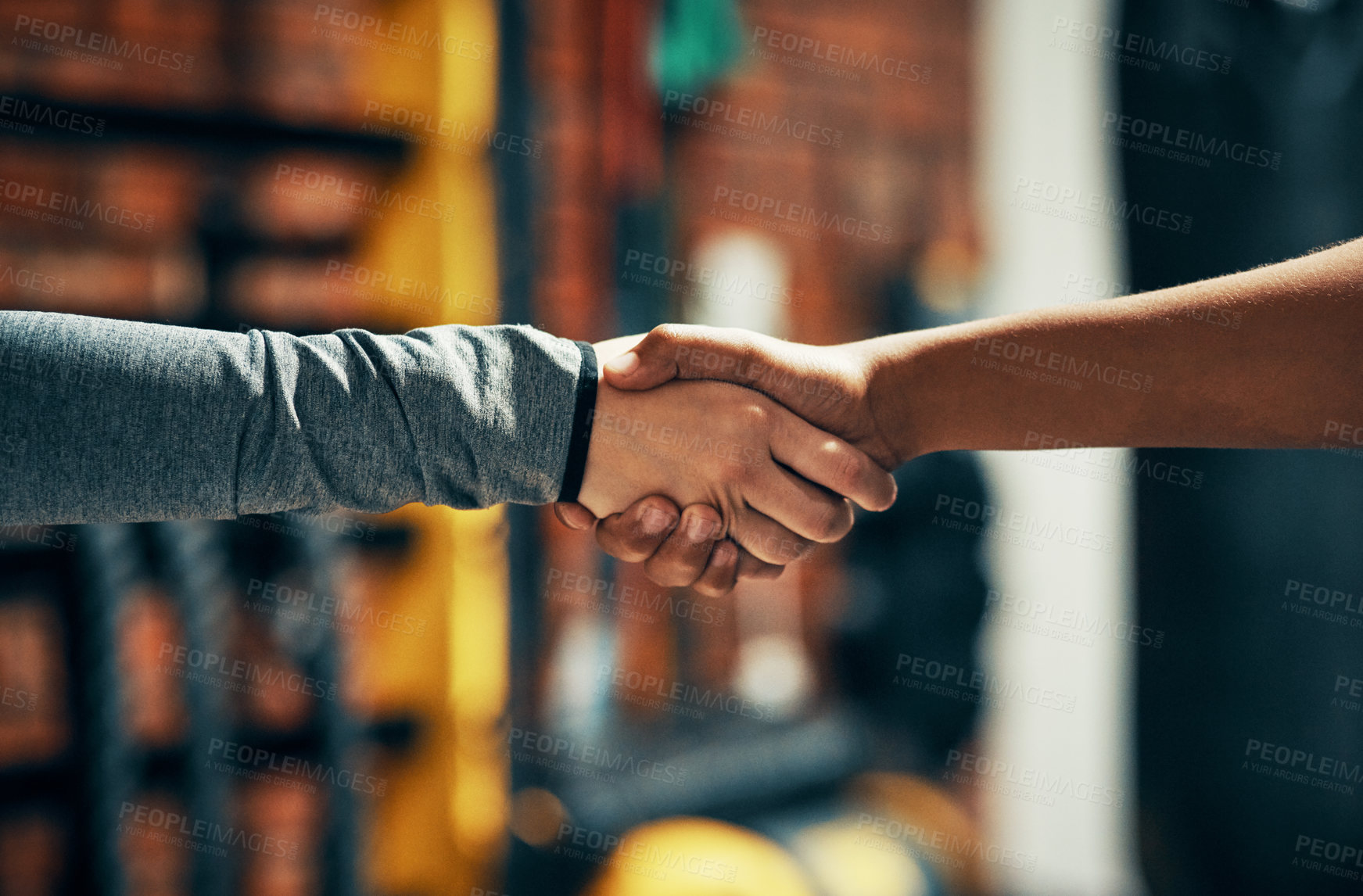 Buy stock photo Cropped shot of two unrecognizable people shaking hands in a gym