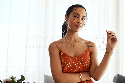 Buy stock photo Cropped portrait of an attractive young businesswoman standing alone in her home office during a day off