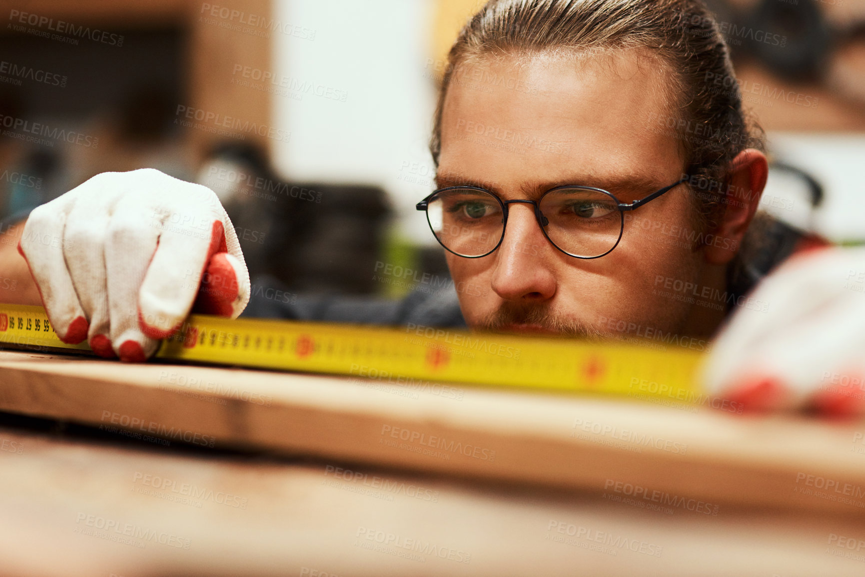 Buy stock photo Man, carpenter and tape to measure wood at workshop, repair and tool for precision design. Male person, builder and manufacturing furniture with equipment, creativity and check plank for construction