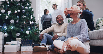 Buy stock photo Happy, group and surprise with friends for Christmas gift, present or month of giving by tree at home. People in relax for holiday, celebration or December party together in living room at house