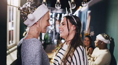 Buy stock photo Woman, lesbian and couple at Christmas party for lgbt celebration, romance or love. Female people, smile and queer pride at social event with friends for festive season or holiday, home or gathering