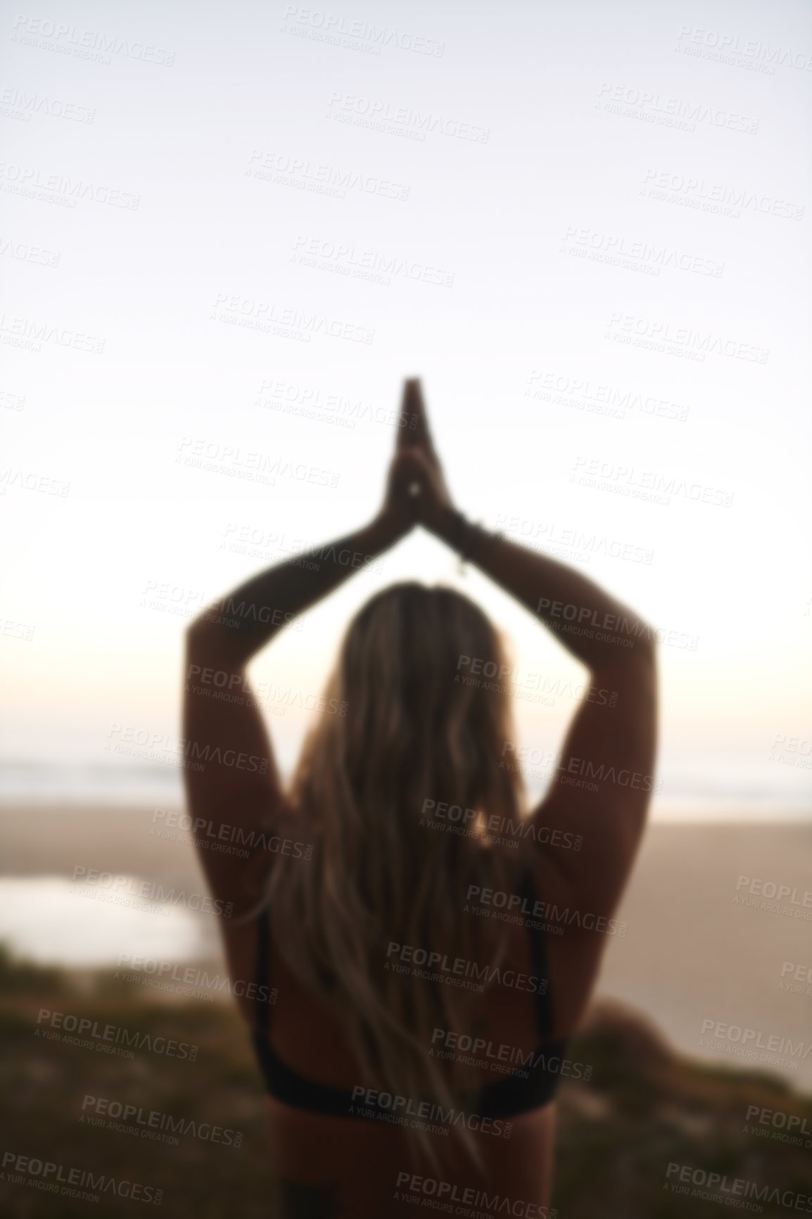 Buy stock photo Cropped shot of an unrecognizable woman standing alone and meditating during a relaxing day outdoors