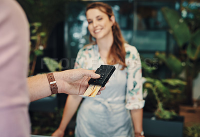 Buy stock photo Cropped shot of an unrecognizable man using his credit card to purchase from a florist
