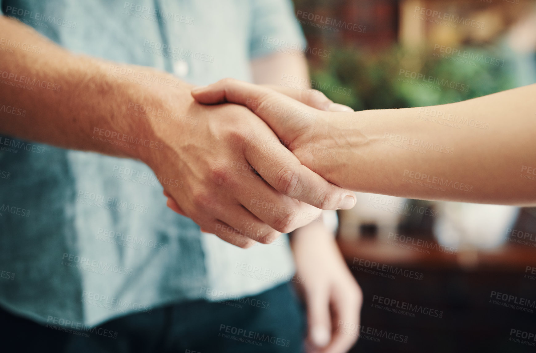 Buy stock photo Cropped shot of two unrecognizable businesspeople standing together and shaking hands after a successful meeting