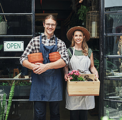 Buy stock photo Man, woman and portrait at shop for florist startup with partnership, happy or open sign at front door. Couple, small business owner and nursery for plants, flowers and sustainable growth in England