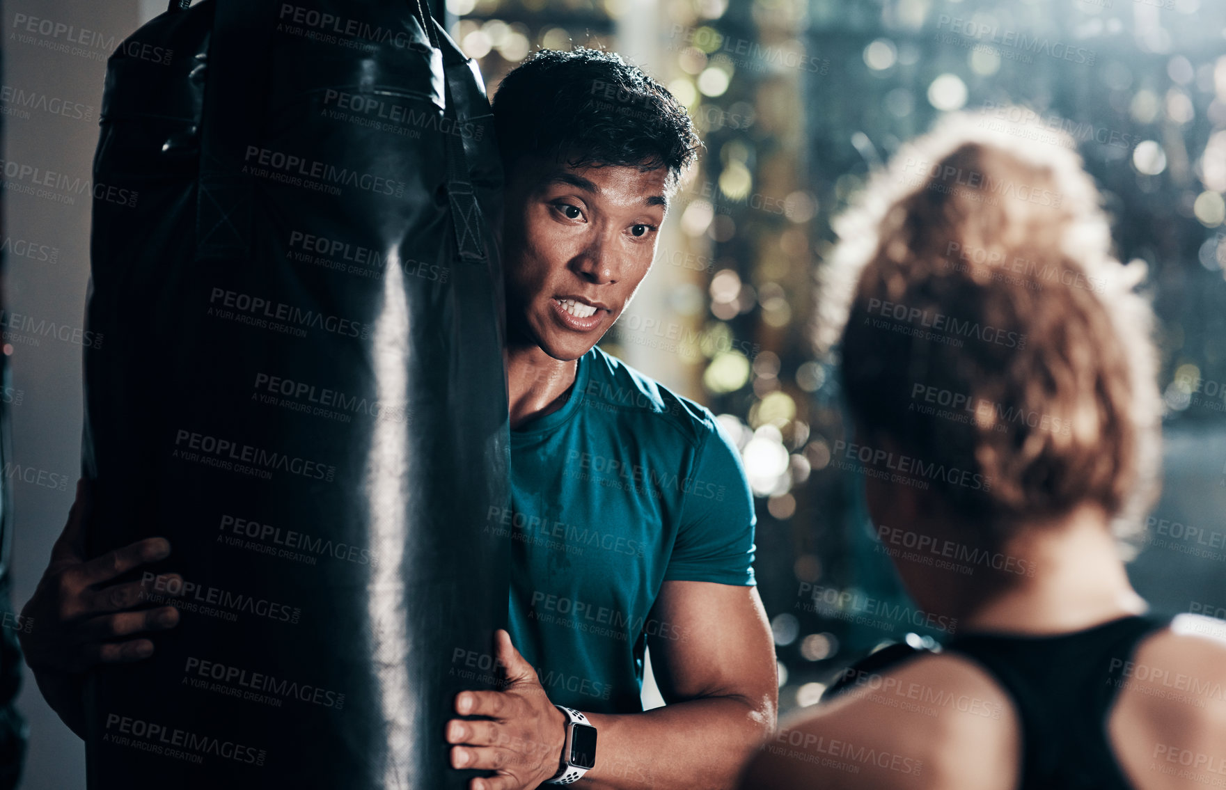 Buy stock photo Fitness, punching bag and woman in gym, personal trainer and practice with instructor, energy and exercise. Health club, sports and endurance of boxer, people and wellness of workout and athlete