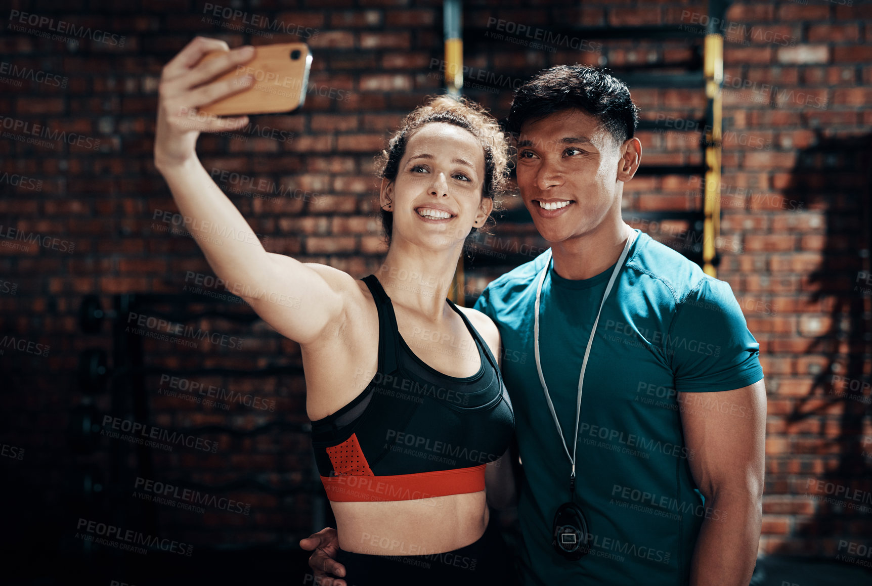Buy stock photo Cropped shot of two young sportspeople taking a selfie together in a gym