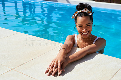 Buy stock photo Shot of a beautiful young woman relaxing in a swimming pool
