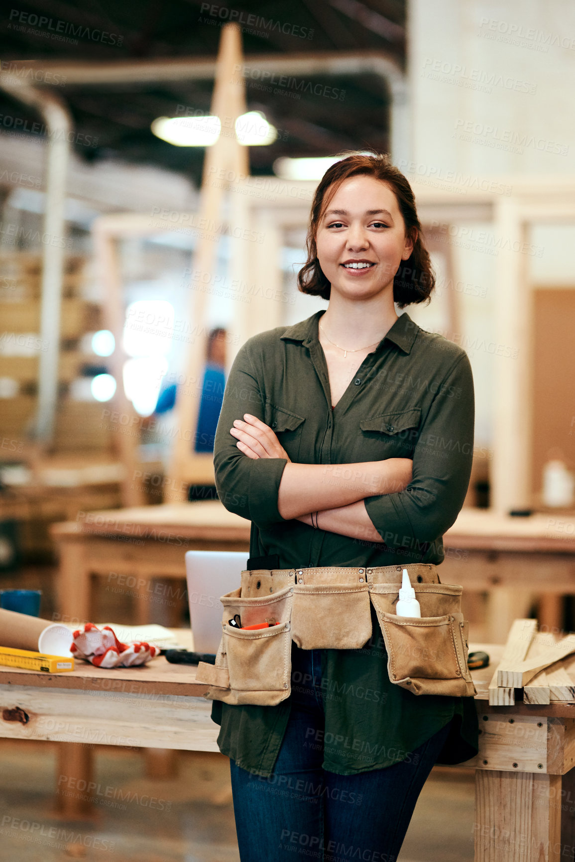 Buy stock photo Cropped shot of a young female carpenter smiling at the camera