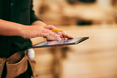 Buy stock photo Shot of a an unrecognizable carpenter using a digital tablet in her workshop