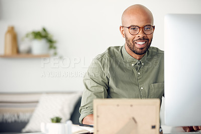 Buy stock photo Cropped shot of a young businessman sitting behind a computer in his office