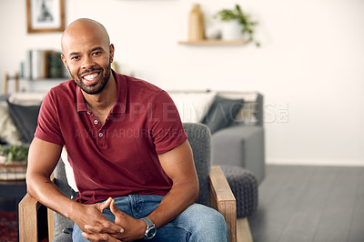 Buy stock photo Cropped shot of a handsome young man sitting at home