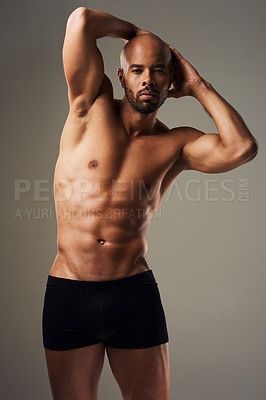 Buy stock photo Portrait of a handsome young man posing in underwear against a grey background