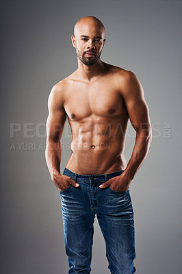 Buy stock photo Portrait of a handsome young man posing shirtless against a grey background