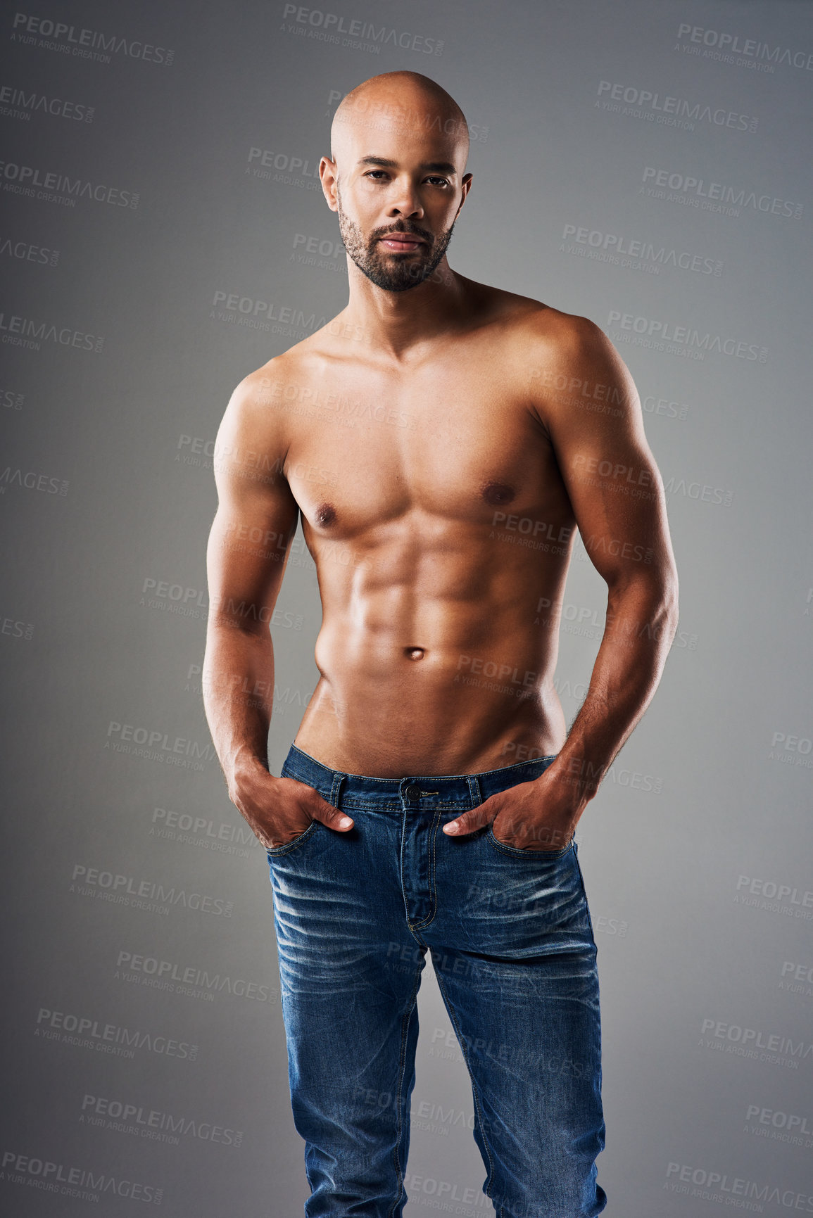 Buy stock photo Portrait of a handsome young man posing shirtless against a grey background