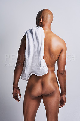 Buy stock photo Rearview shot of a handsome young man posing nude against a grey background